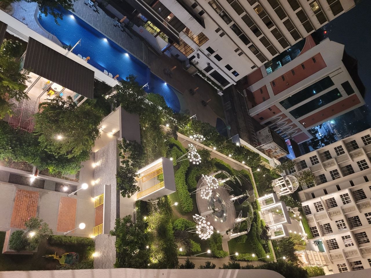 Elevated view over the landscaped garden and swimming pool at night