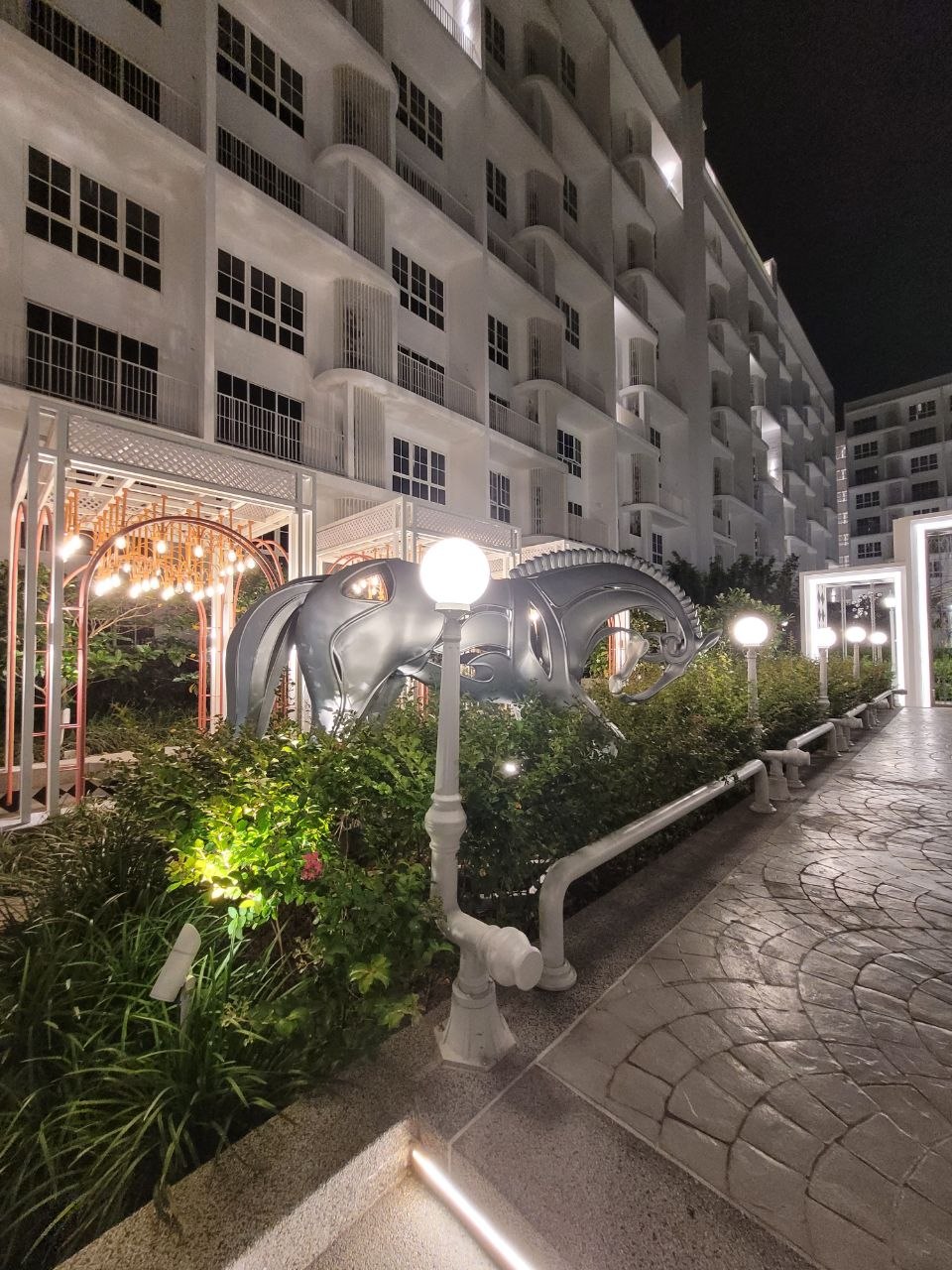 Chrome horse sculptures lining the landscaped garden path