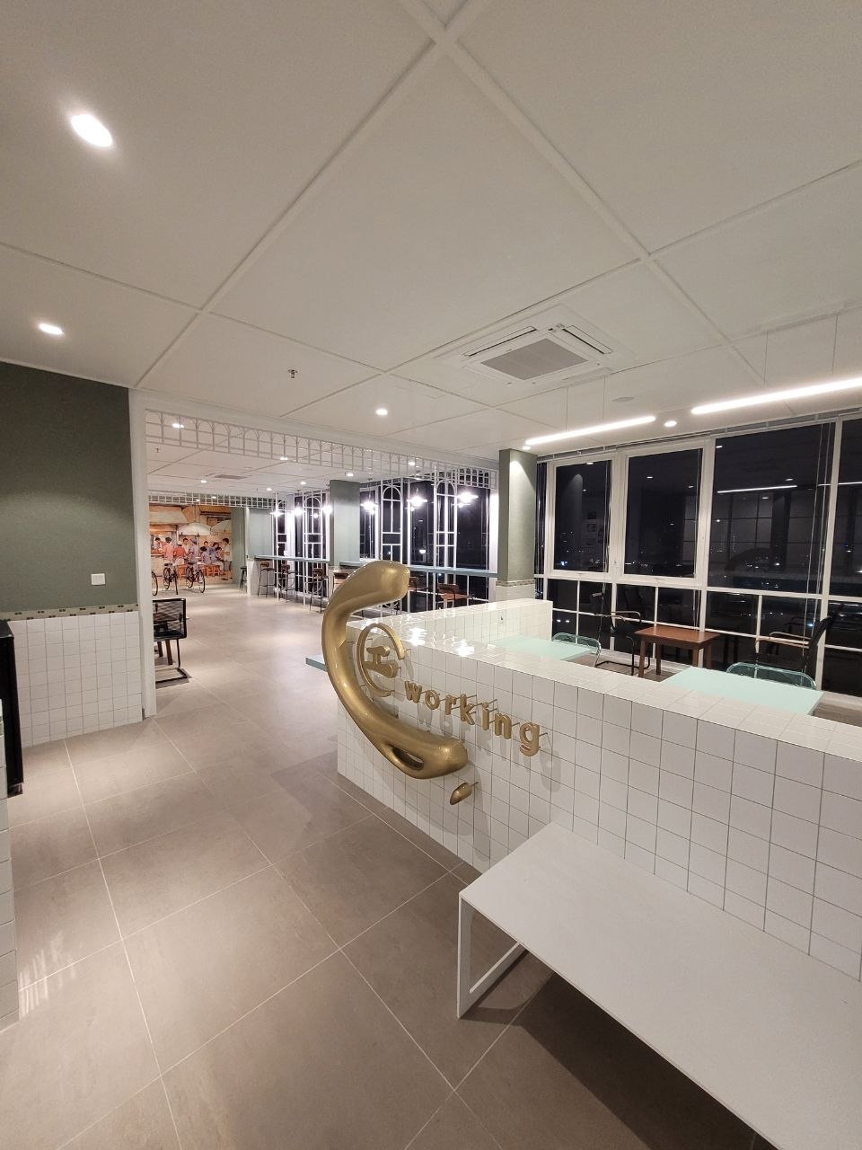 Co-working lounge with tiled counters and huge windows over the city
