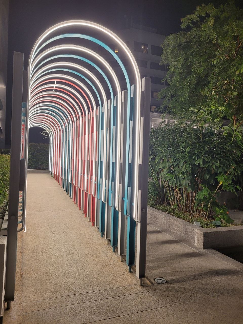 Colourful illuminated arch walkway in the gardens