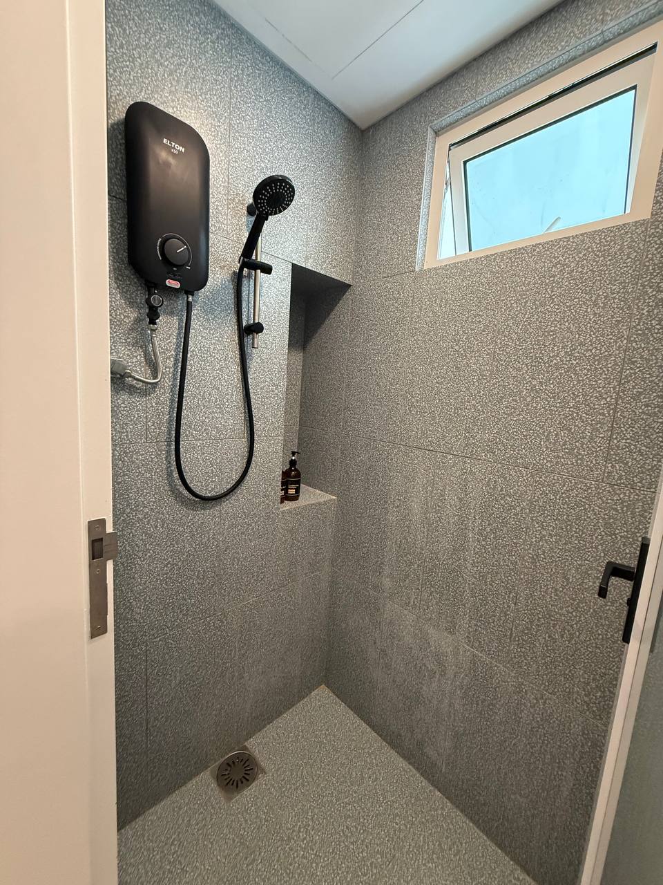 Walk-in shower with water heater and window