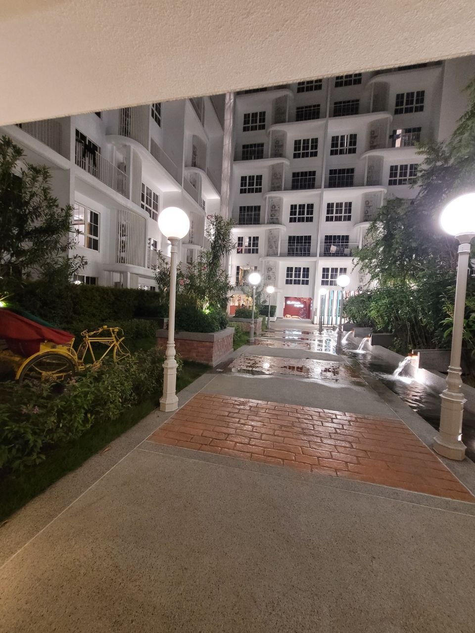 Courtyard walkway with trishaw display and water features